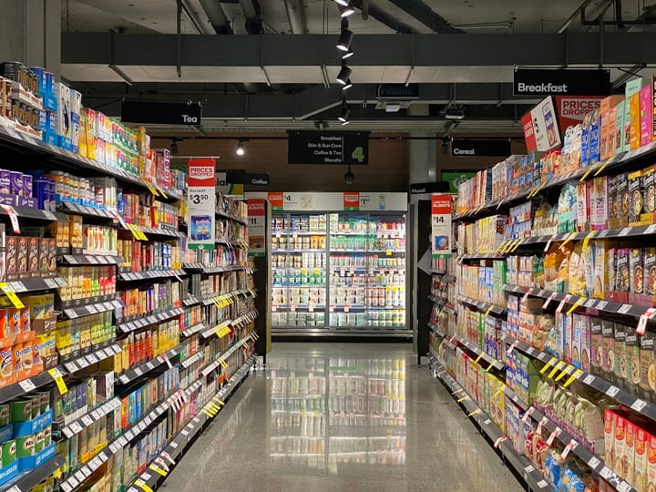 Wide supermarket aisle with shelves — hypermarket scale supply